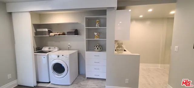 a view of storage and utility room with washer and dryer