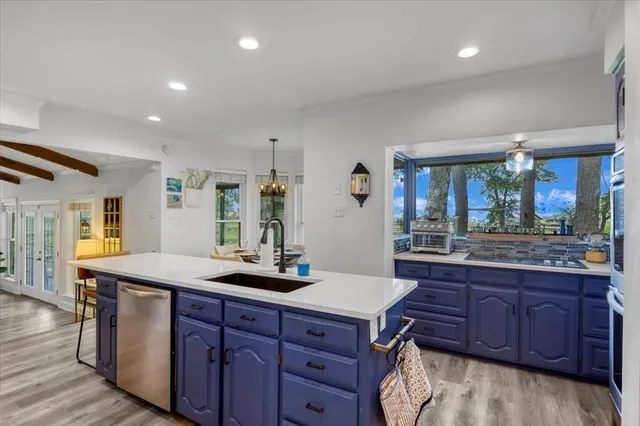 a bathroom with a granite countertop sink and a large mirror