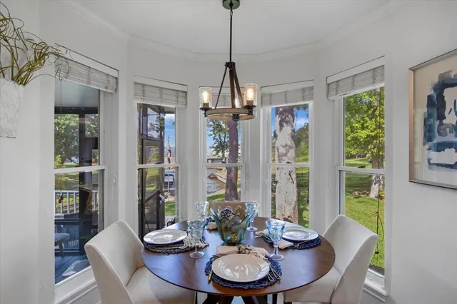 a dining room with furniture a chandelier and wooden floor