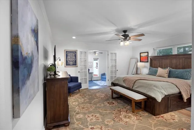 a spacious bedroom with a bed and a chandelier