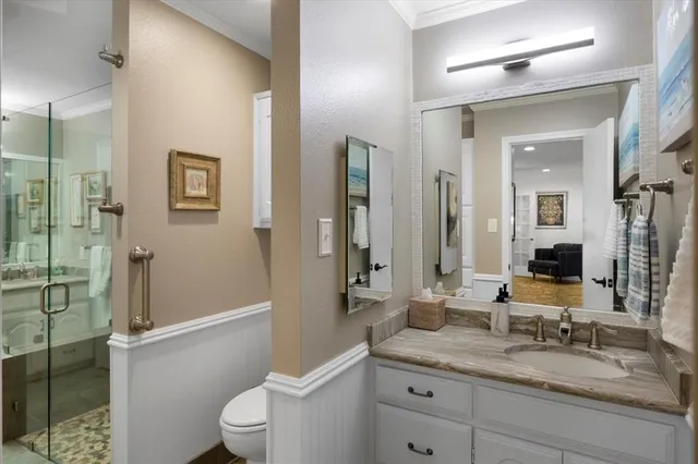 a bathroom with a granite countertop sink toilet and shower