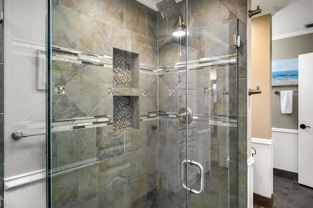 a bathroom with a glass shower door