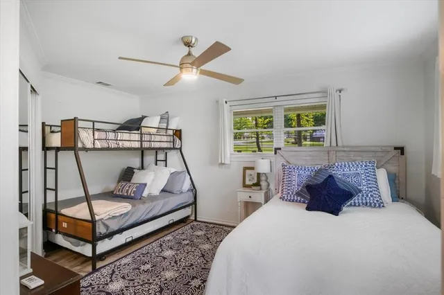 a bedroom with 2 bed and large windows