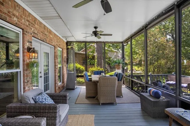 a living room with furniture and a floor to ceiling window