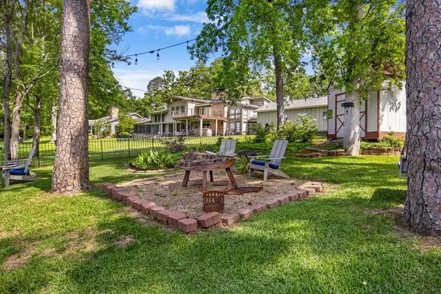a view of a chair and table in backyard of the house