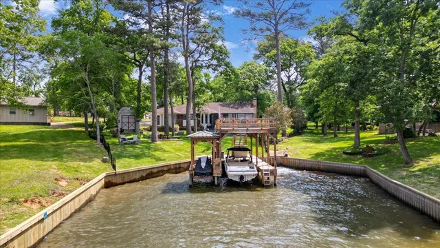 a view of a swimming pool with a patio and a yard