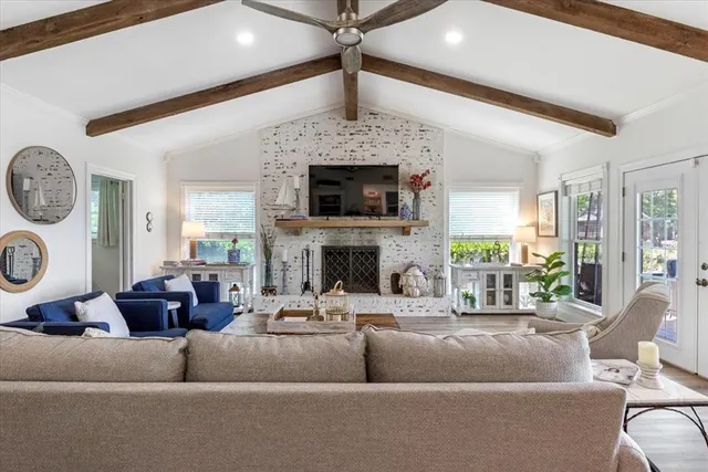a living room with fireplace furniture and a fireplace