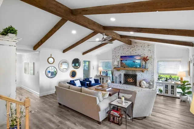 a living room with fireplace furniture and a wooden floor
