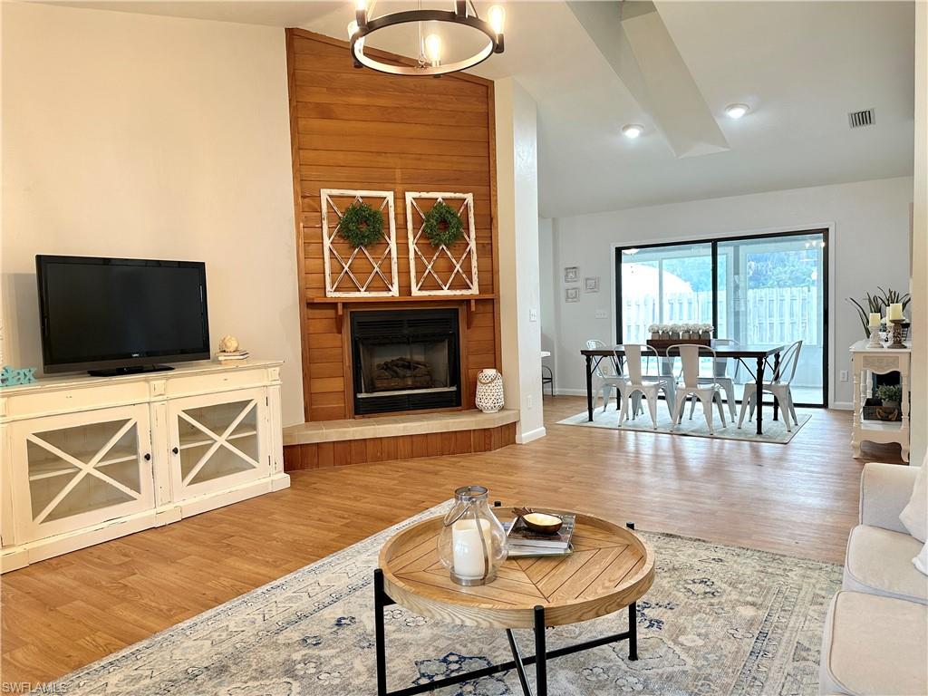 1961 Krape Road Naples, FL 34120 - Photo 11 of 44 a living room with furniture flat screen tv and a fireplace