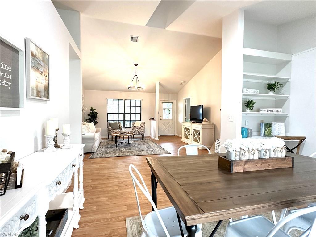 1961 Krape Road Naples, FL 34120 - Photo 20 of 44 a living room with kitchen island furniture and a wooden floor