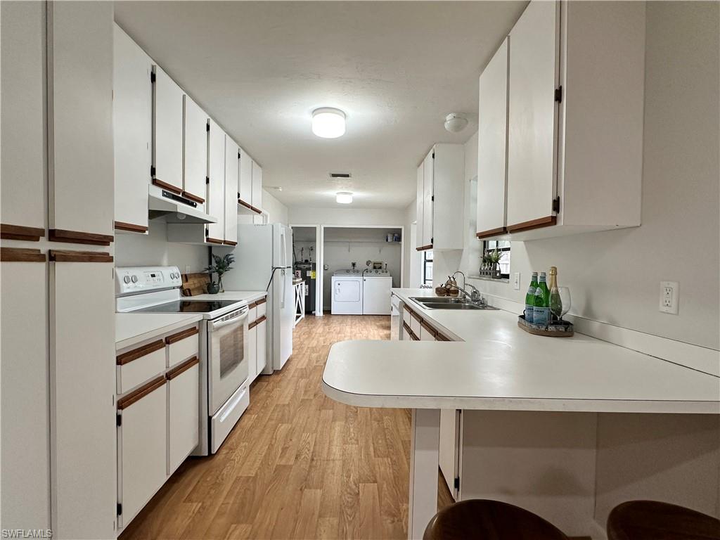1961 Krape Road Naples, FL 34120 - Photo 25 of 44 a kitchen with stainless steel appliances granite countertop a sink a stove and a refrigerator
