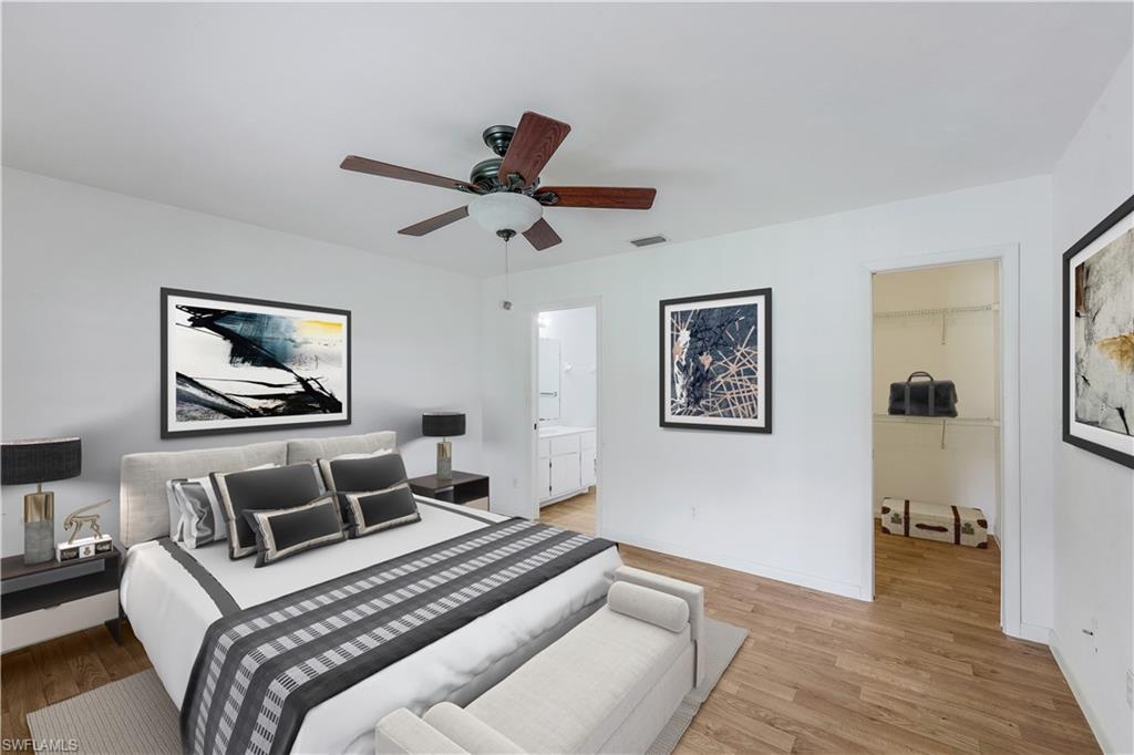 1961 Krape Road Naples, FL 34120 - Photo 31 of 44 a bedroom with a bed and a chandelier