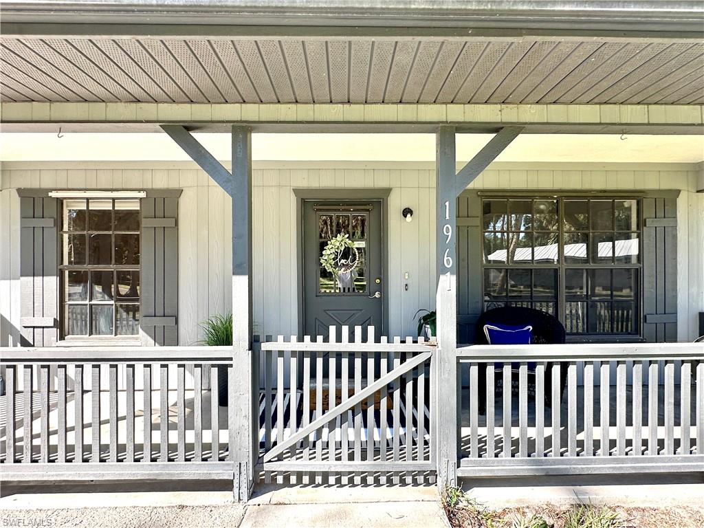1961 Krape Road Naples, FL 34120 - Photo 39 of 44 a view of a porch with a fence