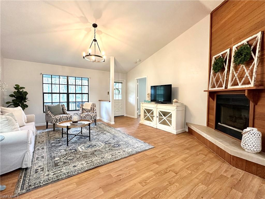 1961 Krape Road Naples, FL 34120 - Photo 4 of 44 a living room with furniture a flat screen tv and a fireplace