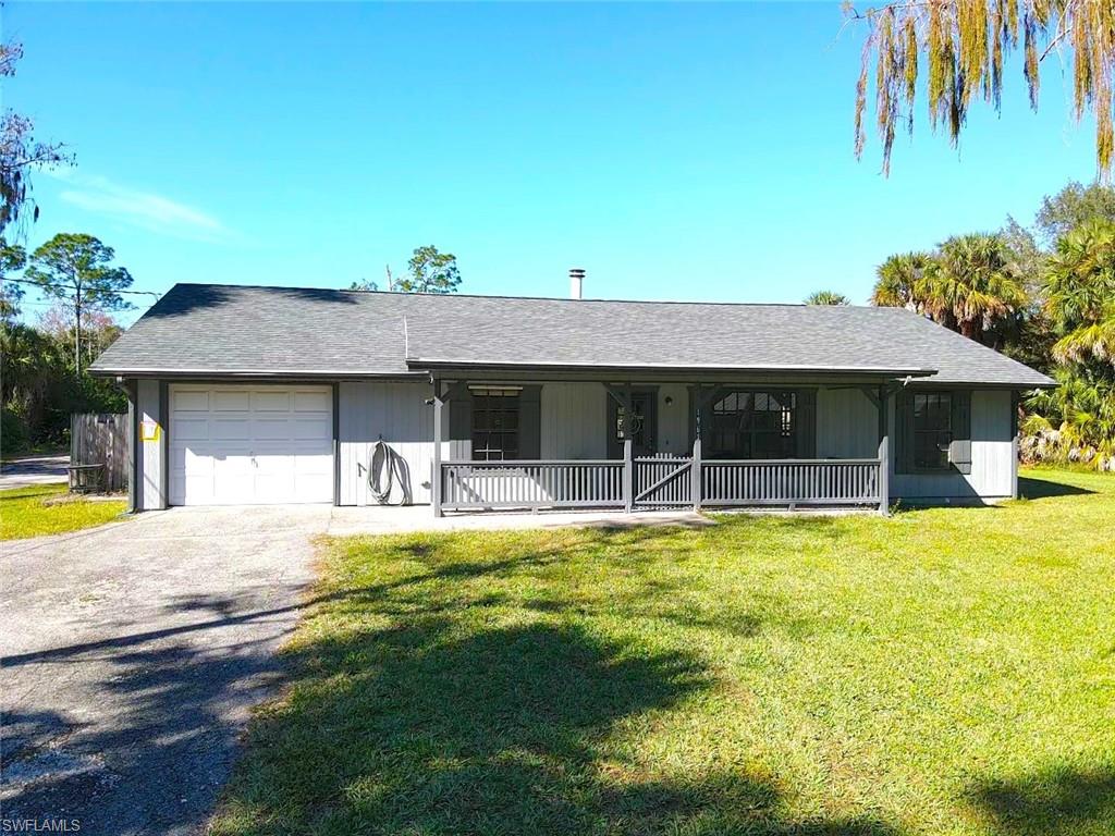 1961 Krape Road Naples, FL 34120 - Photo 8 of 44 a view of a house with swimming pool and a yard