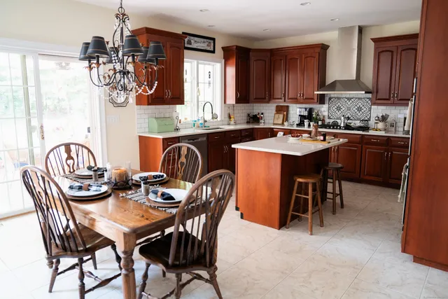 a view of a dining room with furniture and chandelier