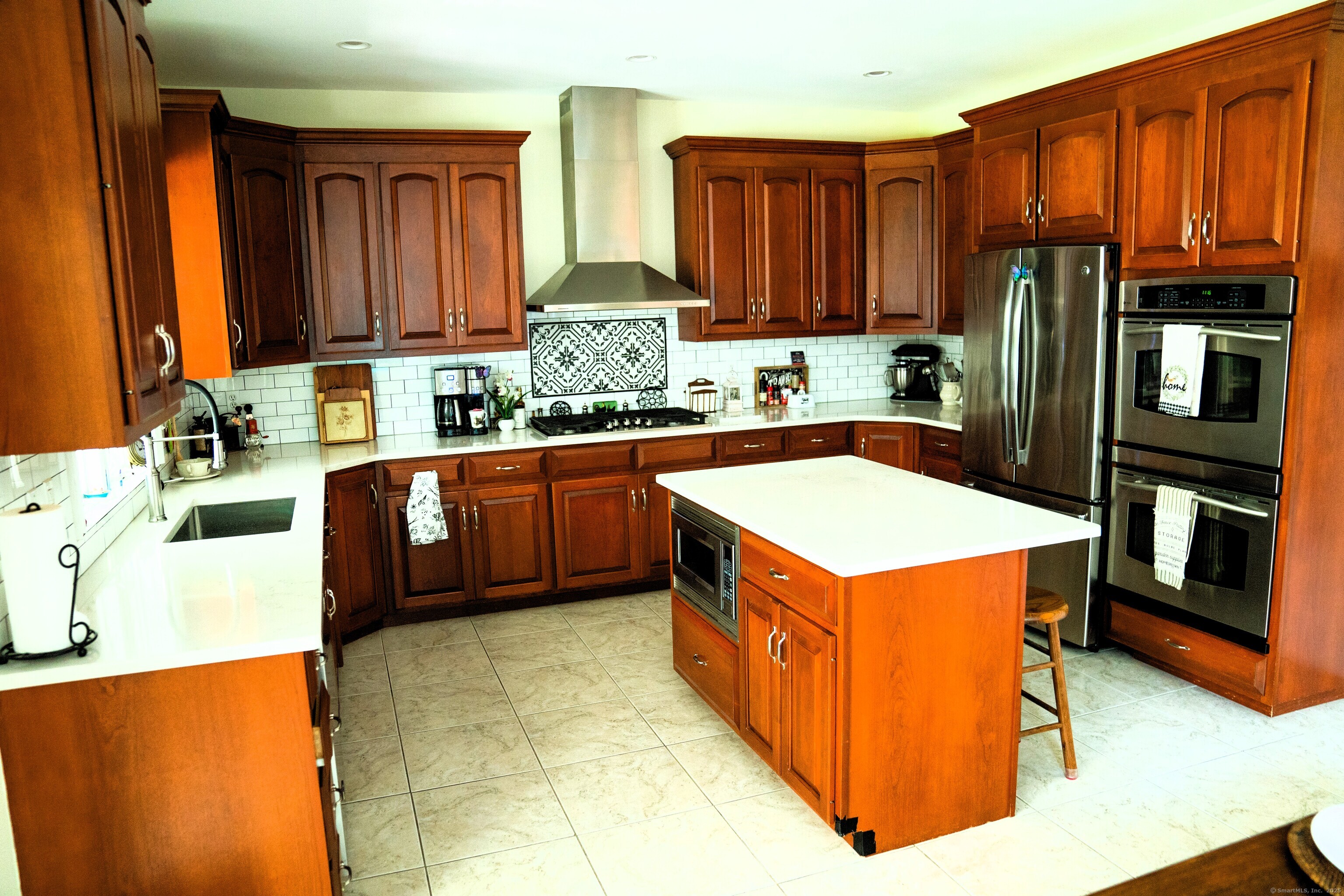 45 North Gate Road Woodbury, CT 06798 - Photo 11 of 40 a kitchen with stainless steel appliances a sink a stove a refrigerator cabinets and a window