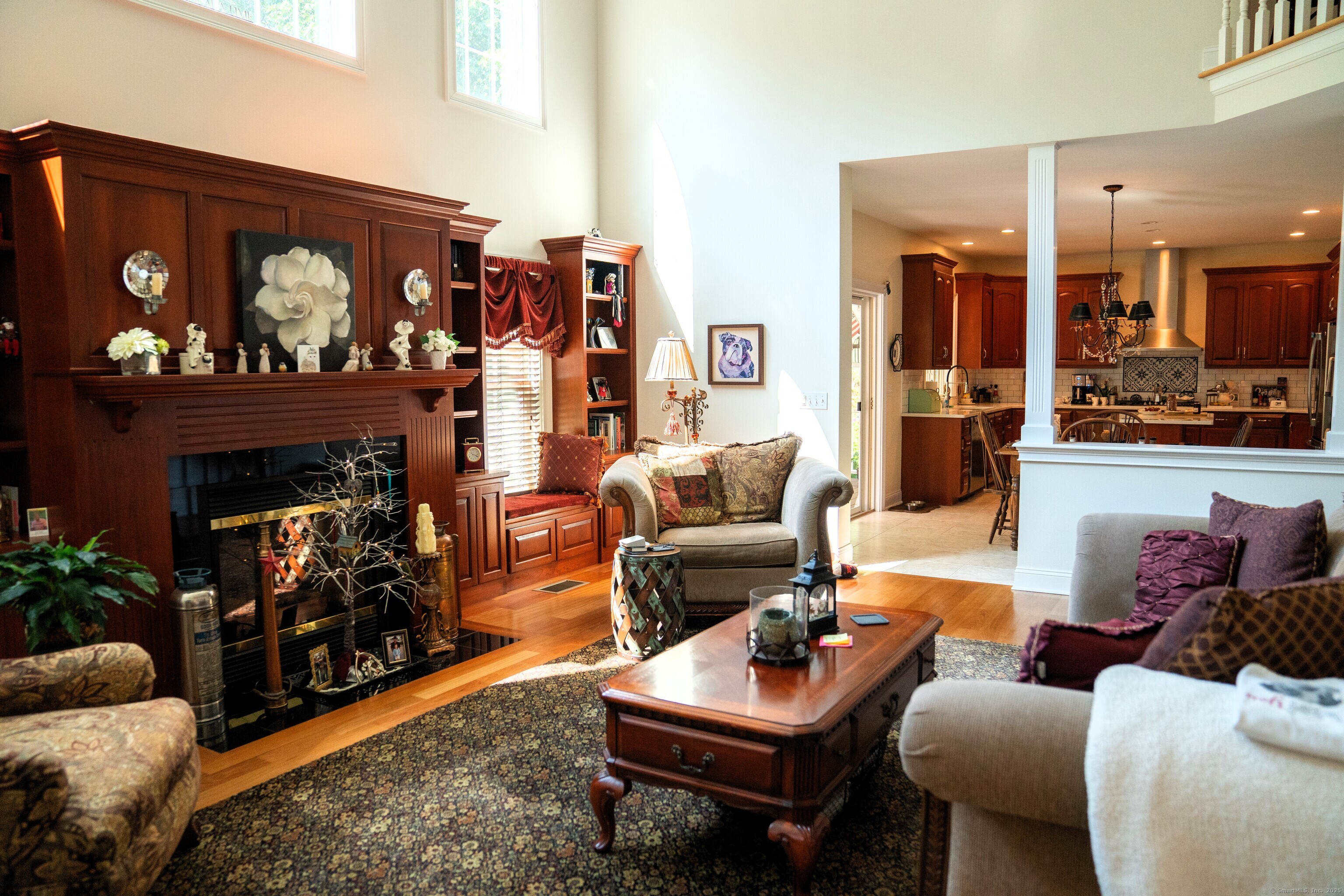 45 North Gate Road Woodbury, CT 06798 - Photo 13 of 40 a living room with furniture a fireplace and kitchen view