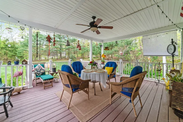 a view of a patio with table and chairs potted plants with wooden floor and outer view