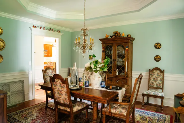 a view of a dining room with furniture and chandelier
