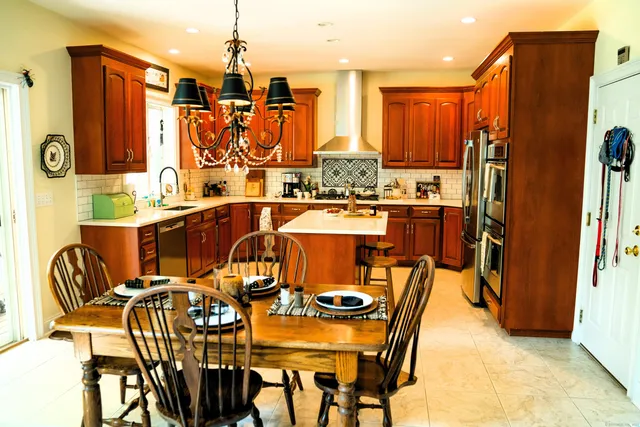 a view of a dining room with furniture and chandelier