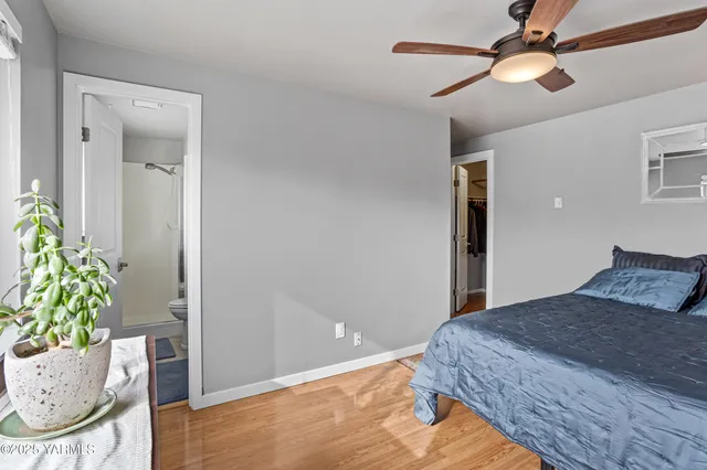 a bedroom with a bed and a potted plant