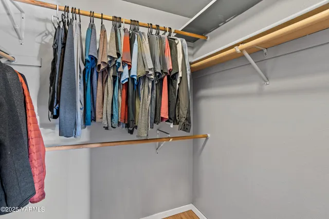 a view of walk in closet with clothes