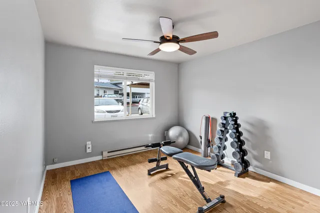 a view of a workspace with wooden floor and a window
