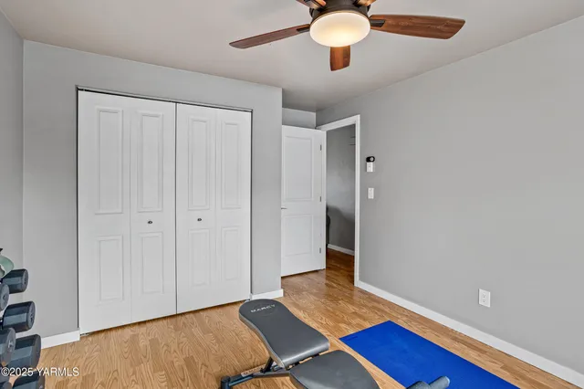 a view of room with wooden floor and fan