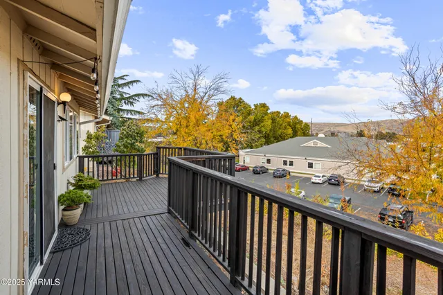a view of a balcony with wooden floor