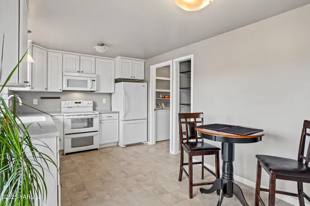 a kitchen with stainless steel appliances a stove a refrigerator and a refrigerator with wooden floor