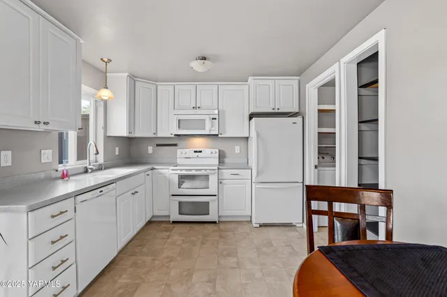 a kitchen with cabinets stainless steel appliances and a window