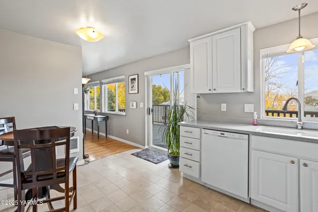 a kitchen with cabinets and chairs