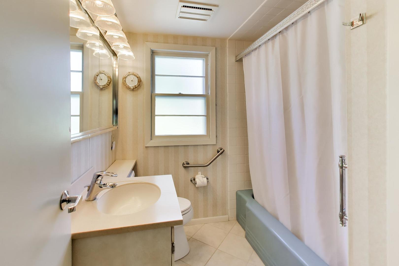 103 Cottonwood Road Northbrook, IL 60062 - Photo 24 of 50 a bathroom with a sink a mirror and a shower