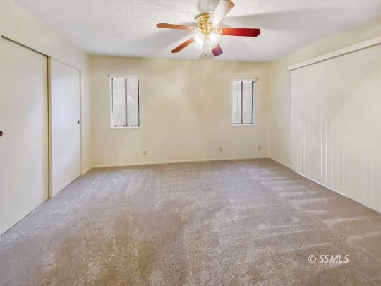 231 Washington Way Ridgecrest, CA 93555 - Photo 10 of 14 an empty room with windows and fan
