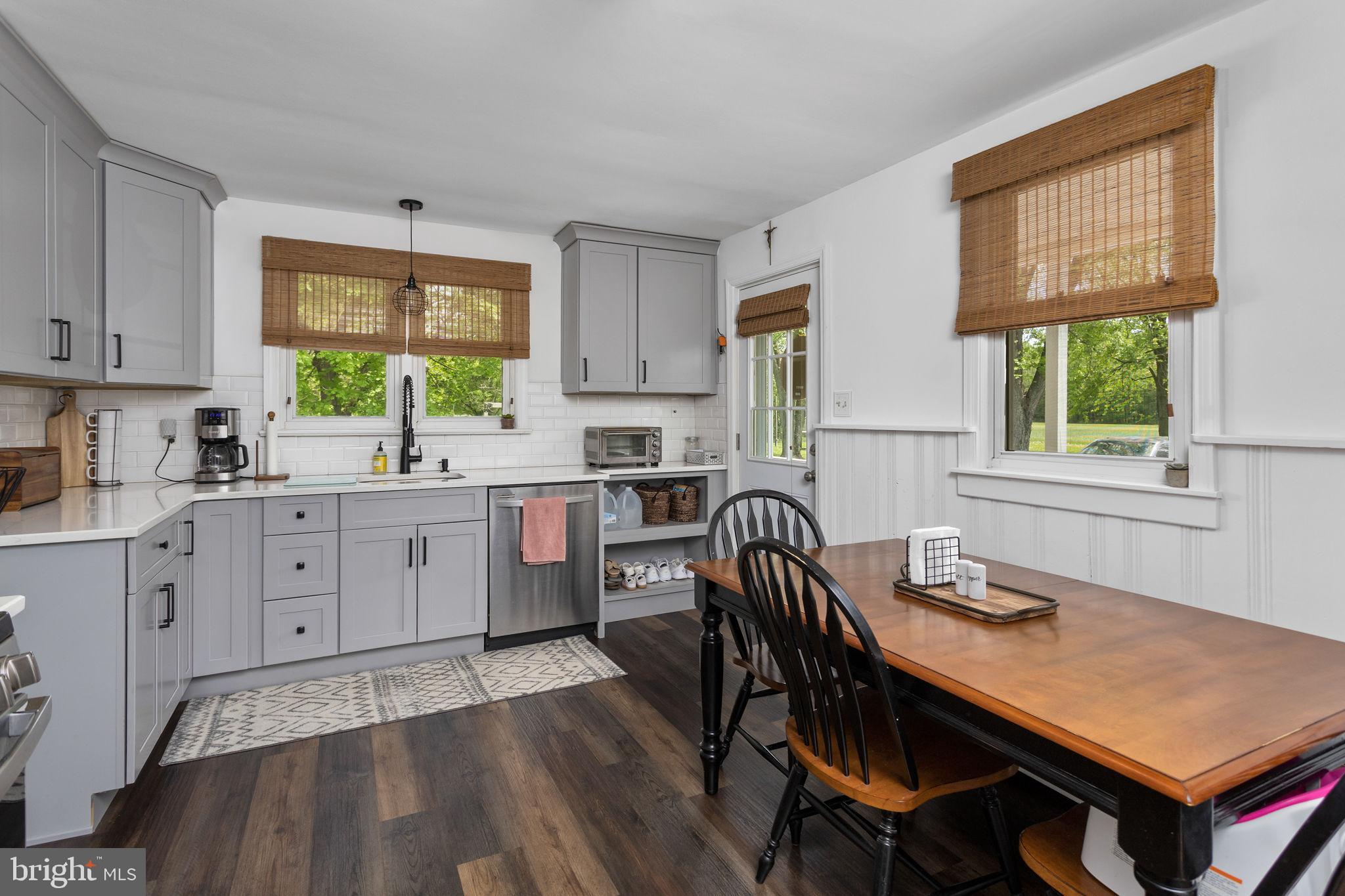 3950 Crosswicks Hamilton Square Road Hamilton, NJ 08691 - Photo 15 of 41 a kitchen with a table chairs a sink dishwasher window and cabinets
