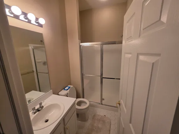 a bathroom with a sink toilet and shower
