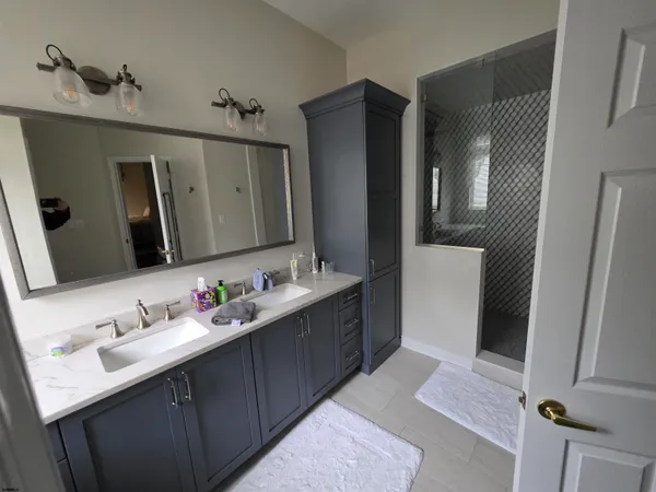 a bathroom with a double vanity sink and mirror