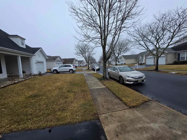 a couple of cars parked in front of a house