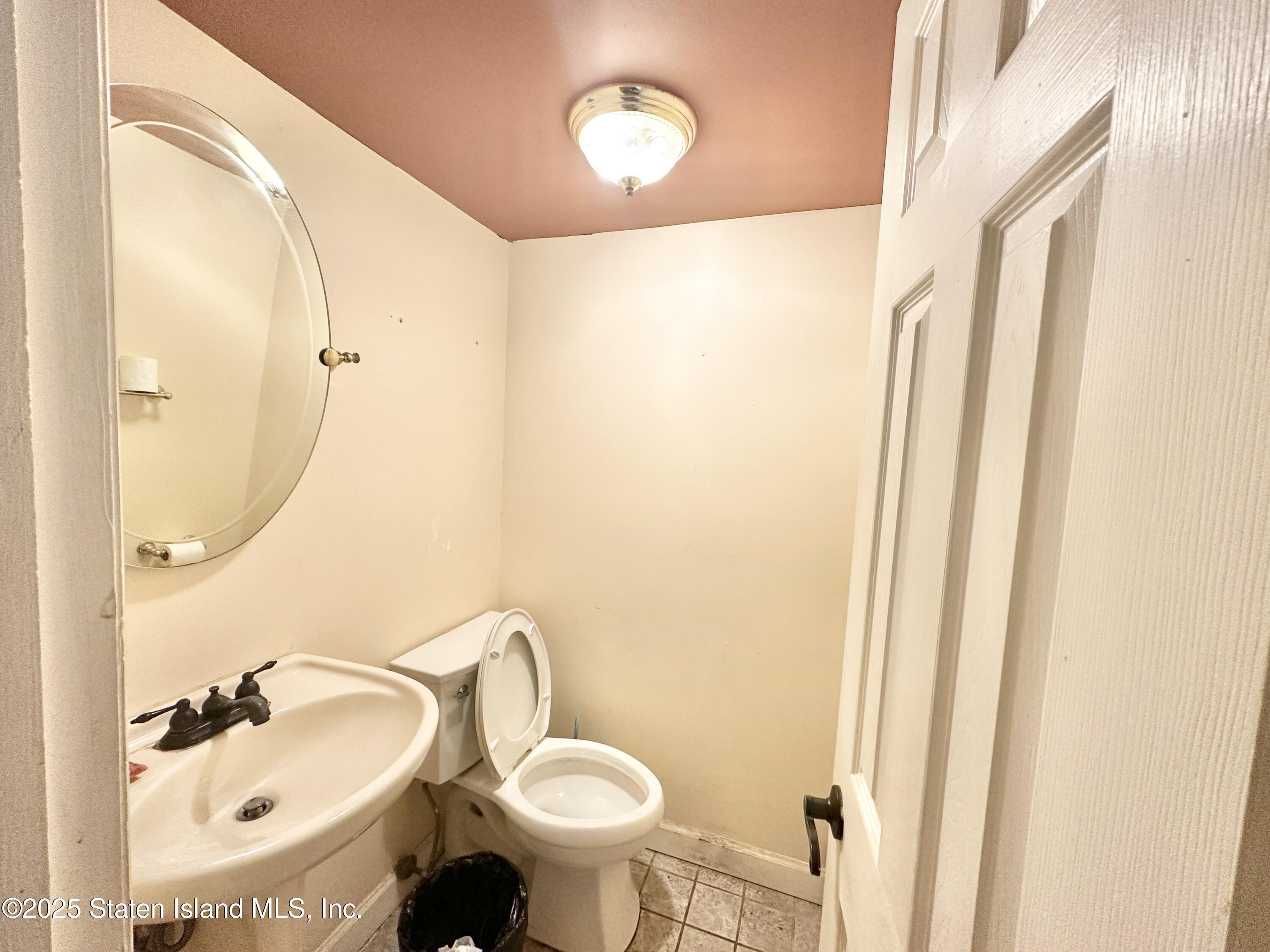 699 Elbe Avenue Staten Island, NY 10304 - Photo 8 of 8 a bathroom with a sink and a mirror