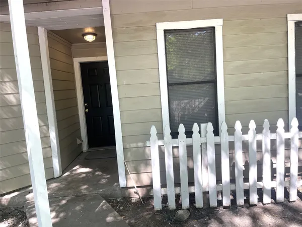 a view of a wooden door with a glass door