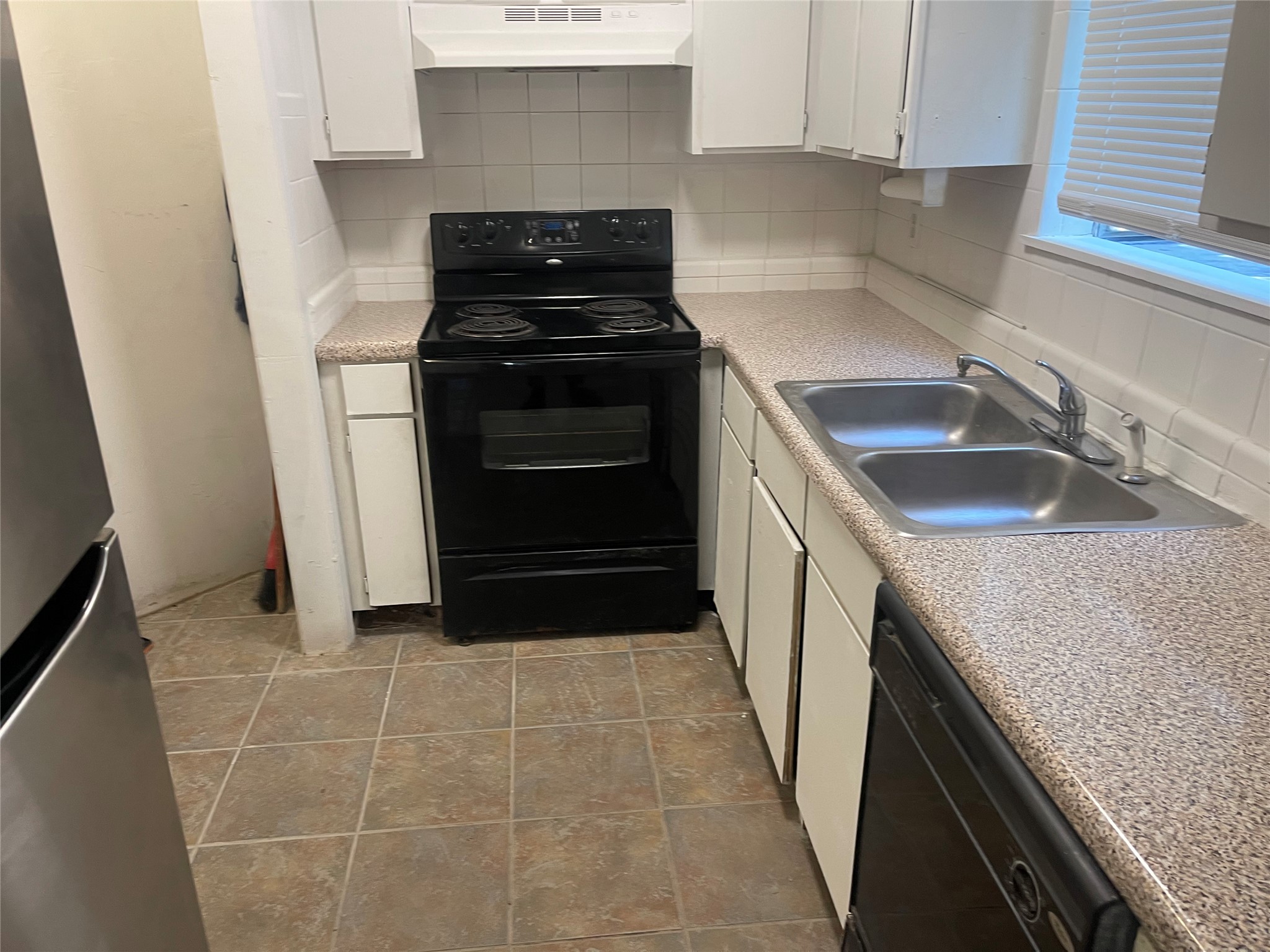 1902 West Loop, Unit A1 Austin, TX 78758 - Photo 14 of 22 a kitchen with a sink stove and cabinets