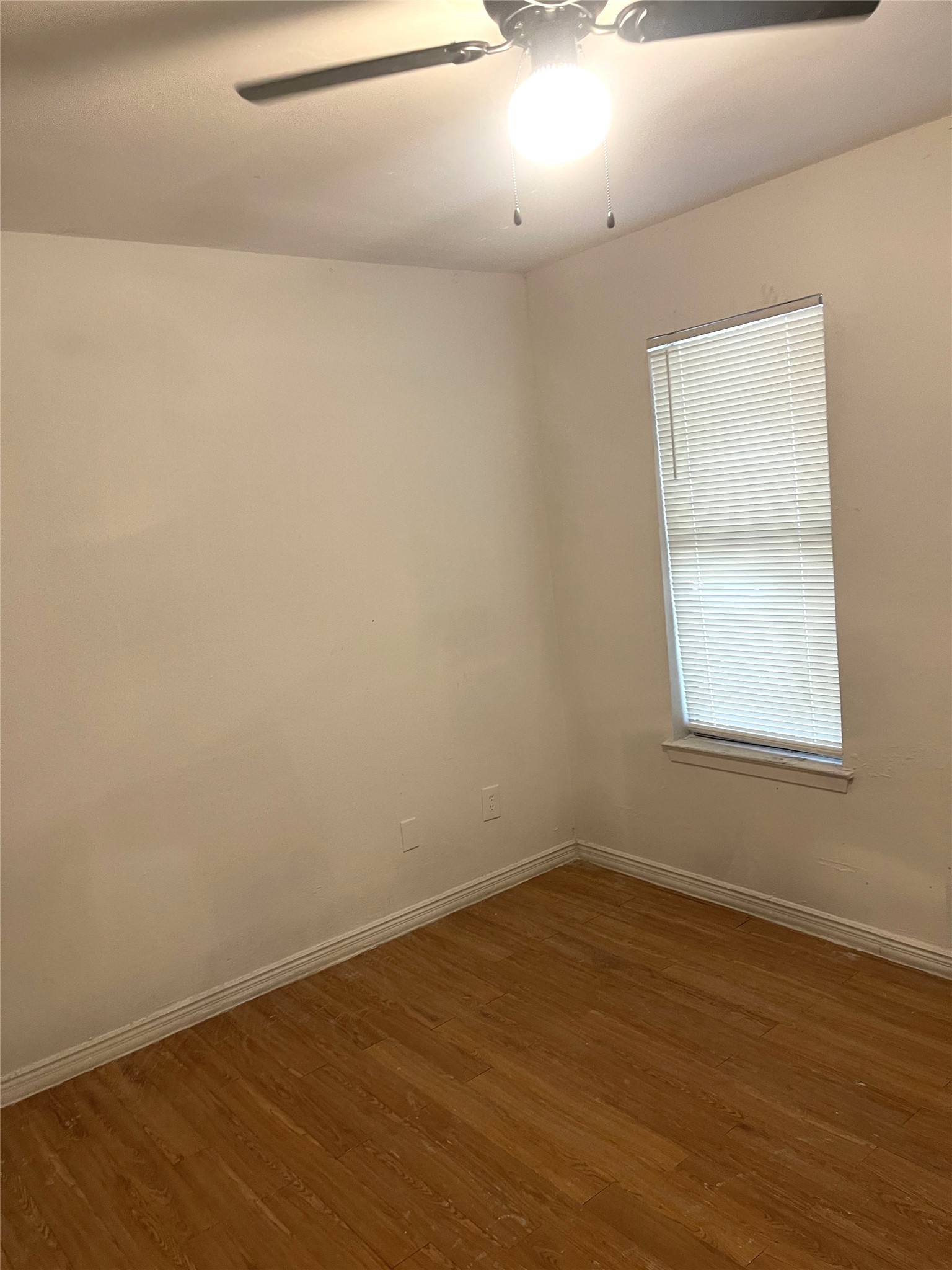 1902 West Loop, Unit A1 Austin, TX 78758 - Photo 7 of 22 an empty room with wooden floor and windows