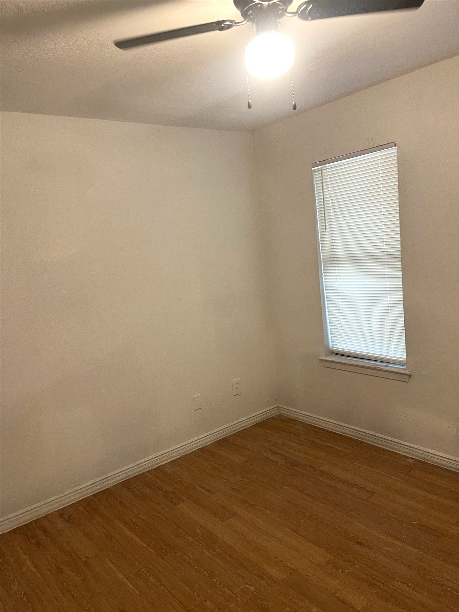 1902 West Loop, Unit A1 Austin, TX 78758 - Photo 8 of 22 an empty room with wooden floor and windows