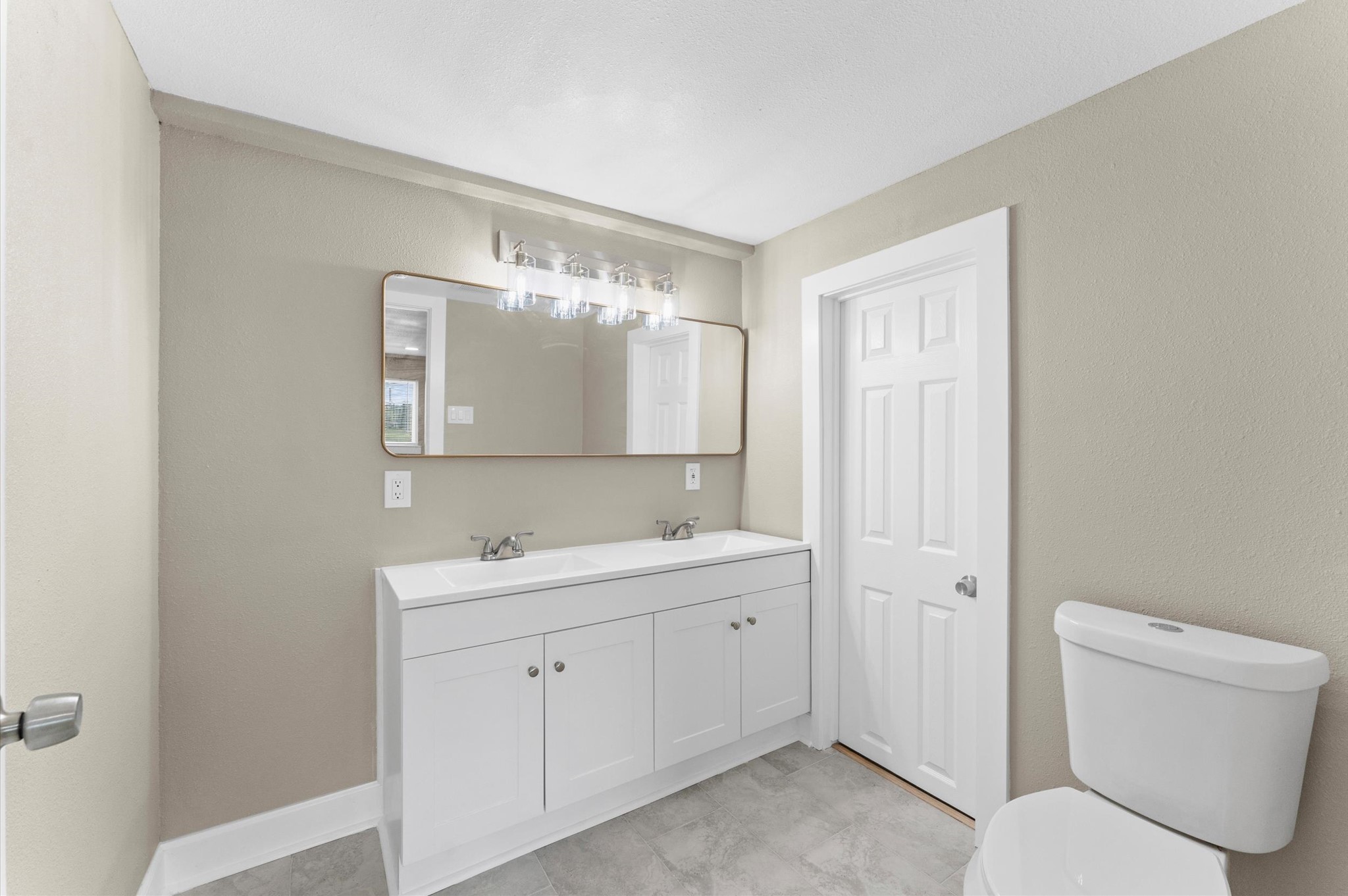 2202 Des Jardines Street Houston, TX 77023 - Photo 21 of 27 a bathroom with a toilet sink and mirror