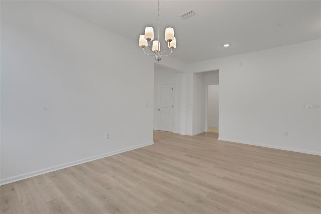 2878 Supermarine Road Tavares, FL 32778 - Photo 11 of 23 a view of a chandelier fan and hardwood floor