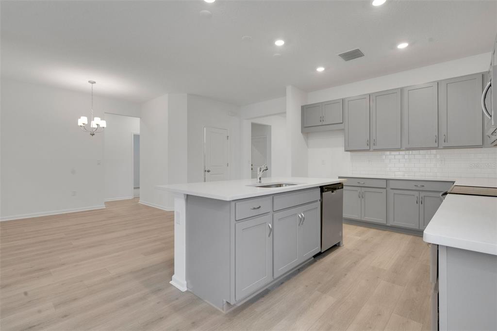 2878 Supermarine Road Tavares, FL 32778 - Photo 17 of 23 a kitchen with granite countertop white cabinets and white appliances