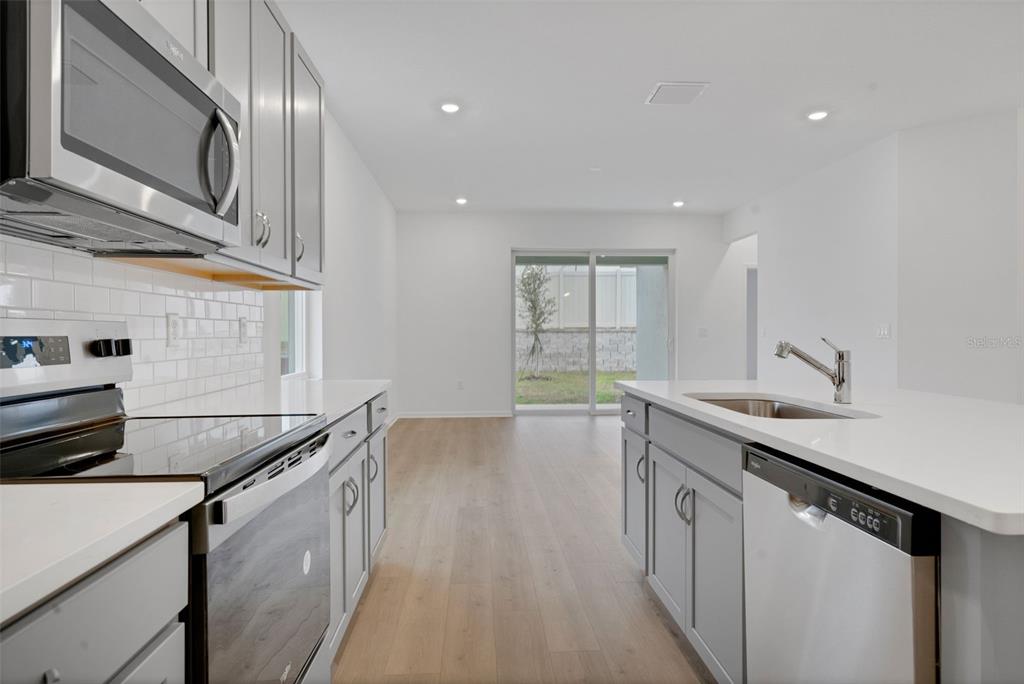 2878 Supermarine Road Tavares, FL 32778 - Photo 18 of 23 a kitchen that has a sink and a stove in it