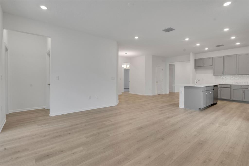 2878 Supermarine Road Tavares, FL 32778 - Photo 20 of 23 a view of an empty room with wooden floor and windows
