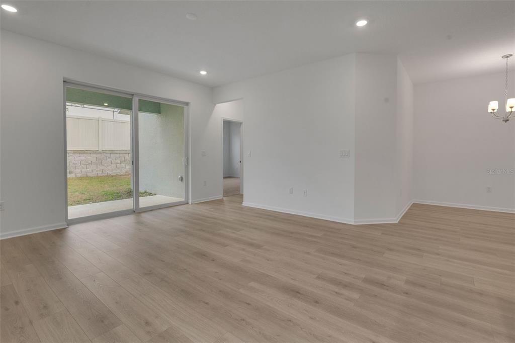 2878 Supermarine Road Tavares, FL 32778 - Photo 21 of 23 a view of an empty room with wooden floor and a window